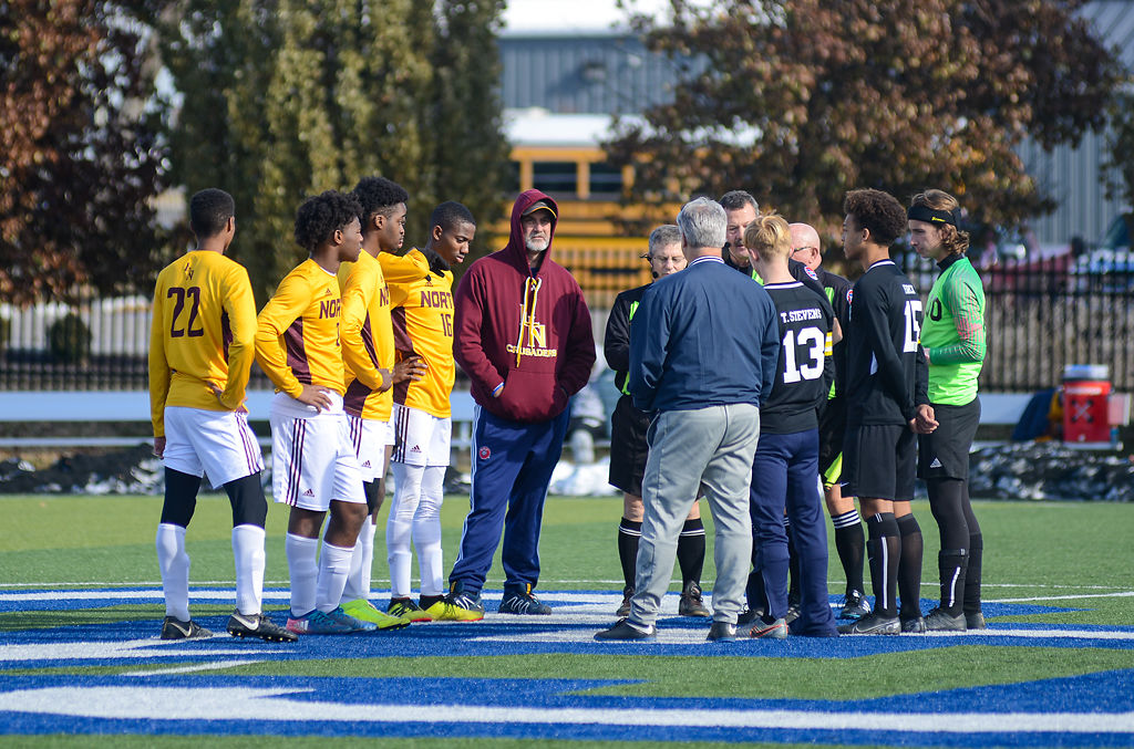 Players from Lutheran North High School and Tolton Catholic High School decide which team will kick-off